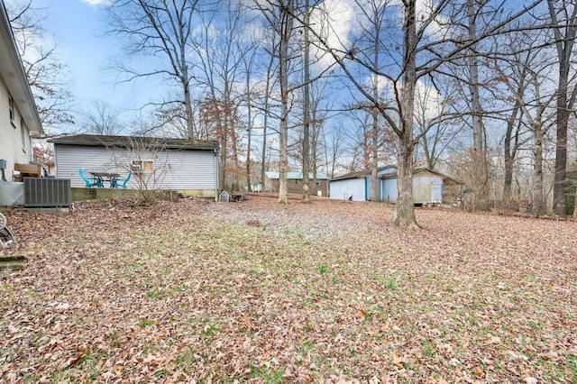 view of yard with central AC and a shed