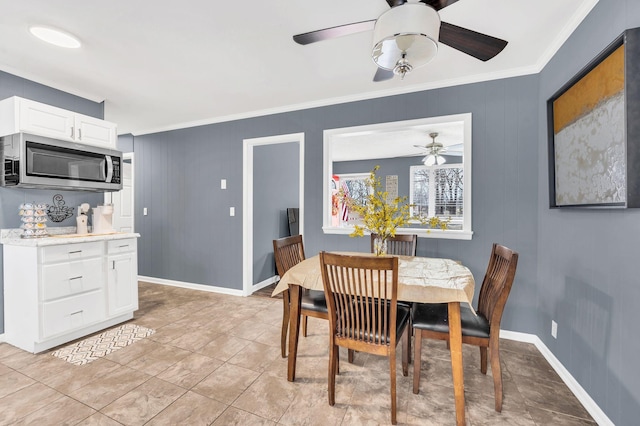 dining area featuring light tile patterned flooring and ornamental molding