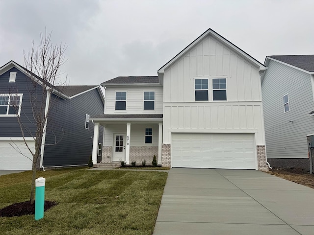 view of front of home with a garage, a front lawn, and covered porch