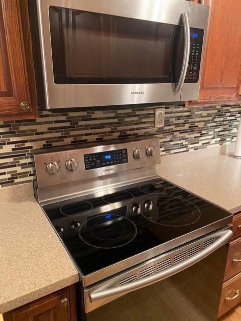 kitchen featuring appliances with stainless steel finishes and backsplash