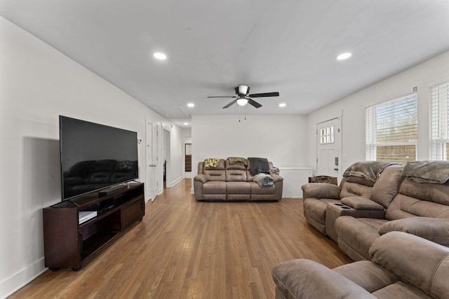 living room with ceiling fan and light wood-type flooring