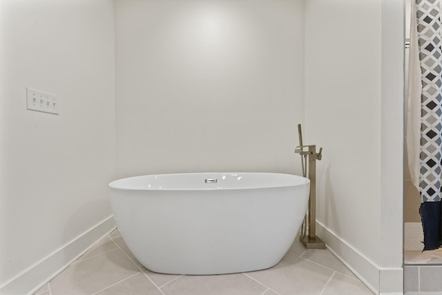 bathroom featuring tile patterned flooring and a bathing tub