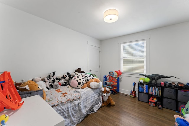 bedroom with dark wood-type flooring