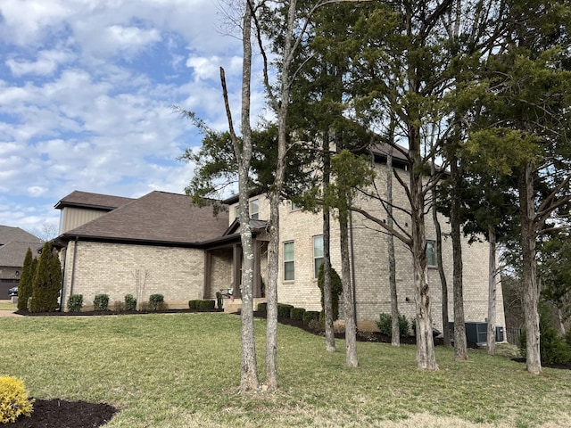 view of side of home featuring a lawn