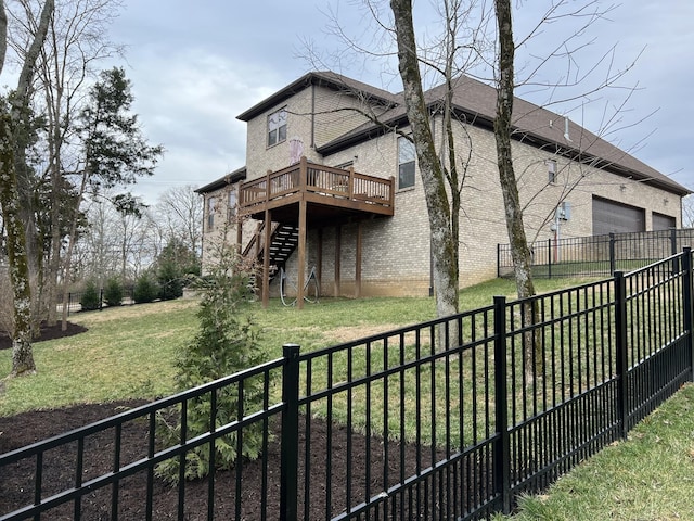 rear view of house with a wooden deck and a yard