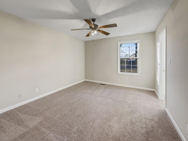 unfurnished room featuring ceiling fan, a textured ceiling, and carpet