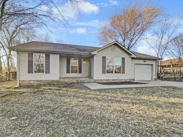 ranch-style home featuring crawl space, driveway, an attached garage, and a front yard