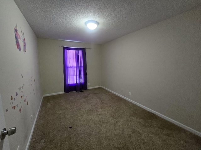 unfurnished room featuring a textured ceiling, carpet flooring, and baseboards