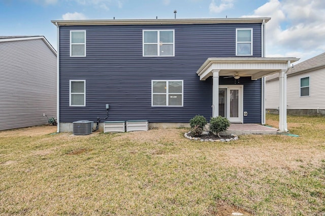 rear view of property featuring central AC unit, a lawn, ceiling fan, and a patio area