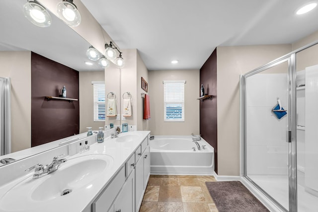 bathroom featuring vanity, shower with separate bathtub, and a healthy amount of sunlight