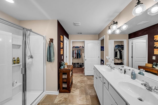 bathroom featuring vanity and a shower with shower door