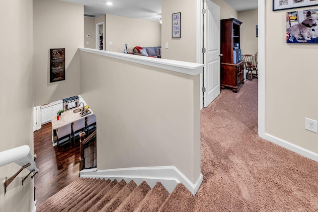 corridor with dark colored carpet