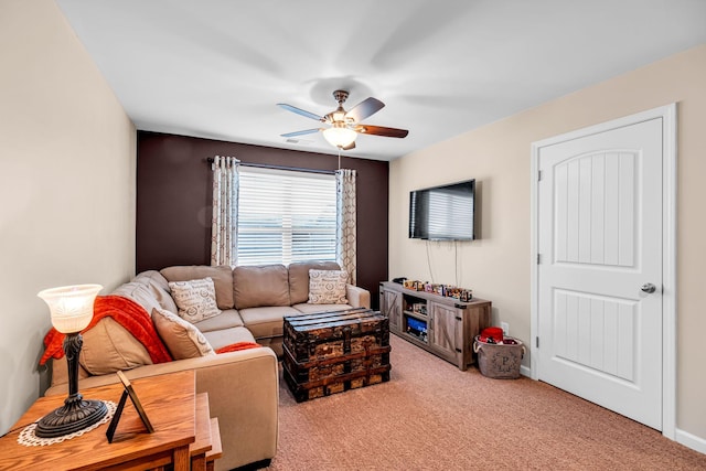 carpeted living room with ceiling fan