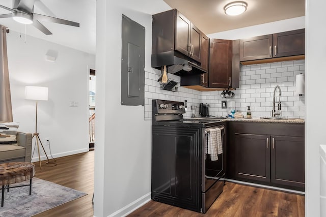 kitchen with black electric range oven, dark hardwood / wood-style flooring, decorative backsplash, electric panel, and dark brown cabinets