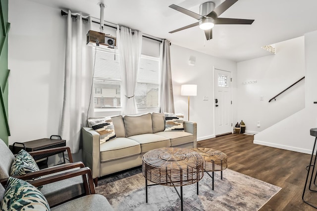 living room featuring ceiling fan and dark hardwood / wood-style floors