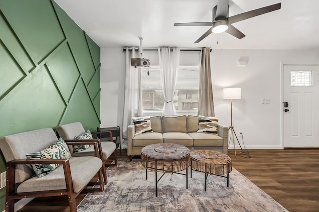 living room featuring ceiling fan and hardwood / wood-style floors