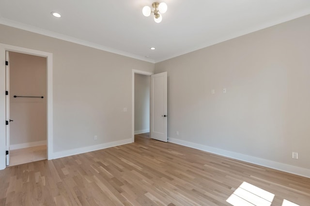 unfurnished bedroom featuring ornamental molding and light wood-type flooring