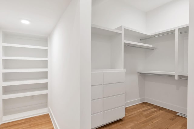 spacious closet with hardwood / wood-style floors