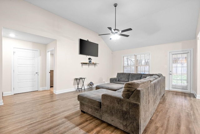 living room featuring vaulted ceiling, ceiling fan, and light hardwood / wood-style floors