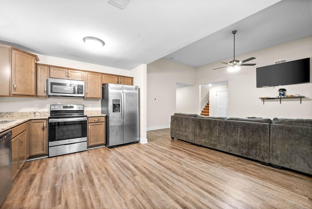 kitchen with stainless steel appliances, ceiling fan, and light wood-type flooring