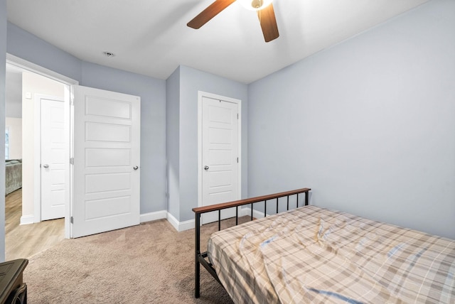 bedroom with ceiling fan, carpet flooring, and a closet