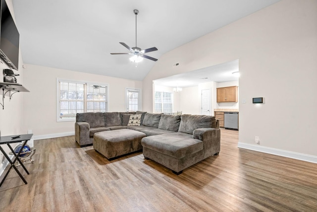 living room with ceiling fan, high vaulted ceiling, and light hardwood / wood-style floors