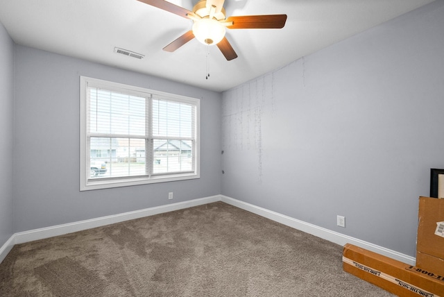 empty room with ceiling fan and carpet flooring