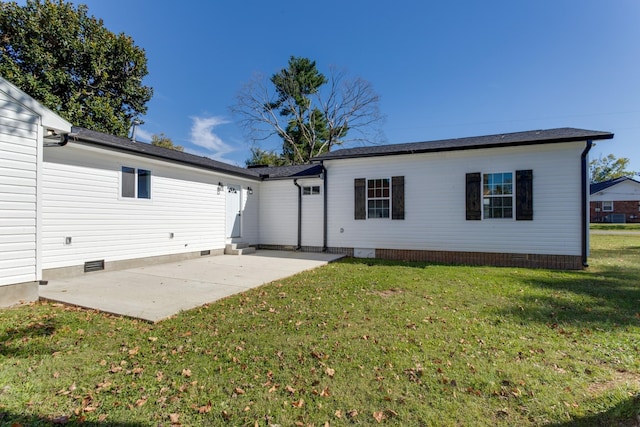 rear view of property with a patio and a yard