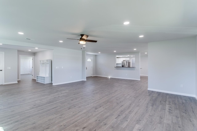 unfurnished living room featuring light hardwood / wood-style floors and ceiling fan