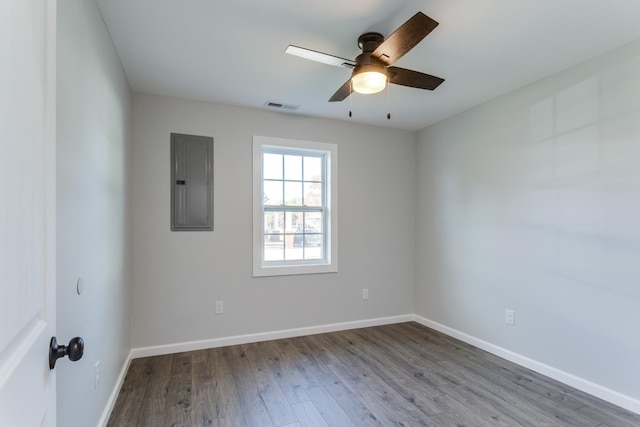 empty room with wood-type flooring, electric panel, and ceiling fan