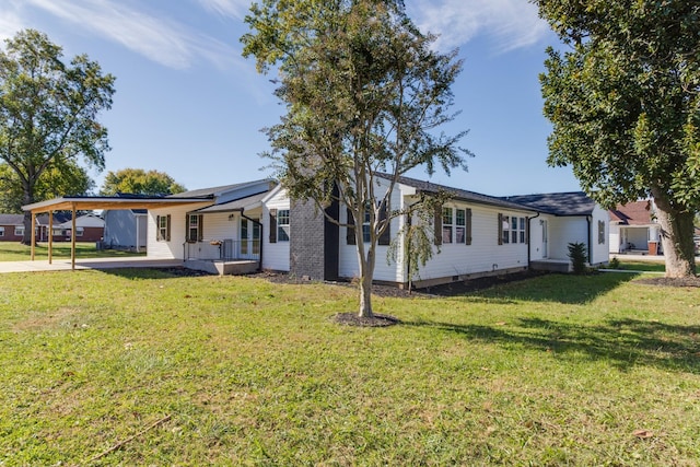 ranch-style house with a carport and a front lawn