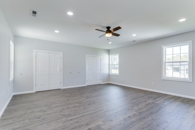 empty room with ceiling fan and light wood-type flooring