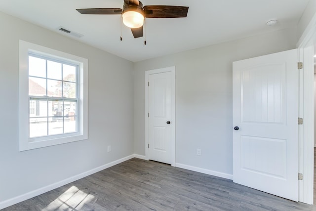 unfurnished bedroom featuring light hardwood / wood-style floors, a closet, and ceiling fan