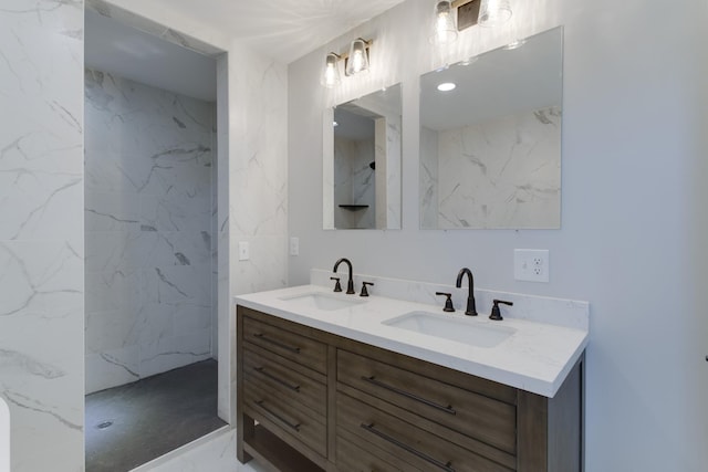 bathroom with vanity and a tile shower