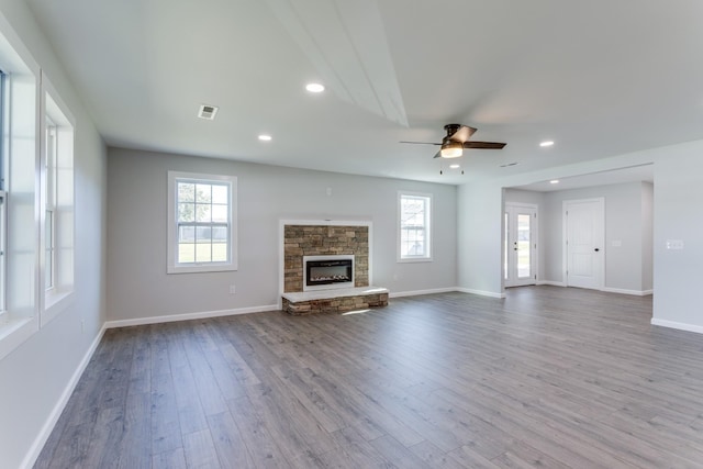 unfurnished living room featuring ceiling fan, a fireplace, and hardwood / wood-style floors