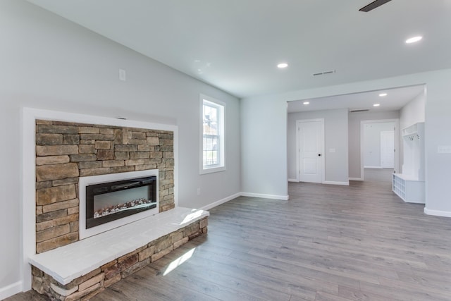 unfurnished living room with hardwood / wood-style floors and a fireplace