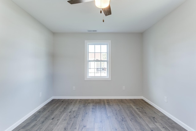 empty room with ceiling fan and light hardwood / wood-style flooring