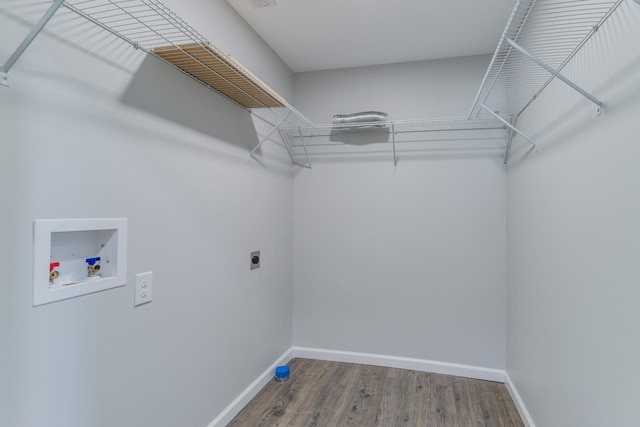 clothes washing area with hardwood / wood-style flooring, hookup for an electric dryer, and hookup for a washing machine