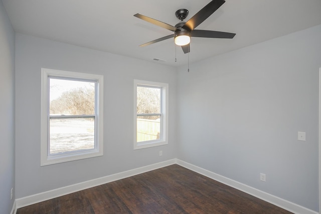 empty room with dark wood-type flooring and ceiling fan