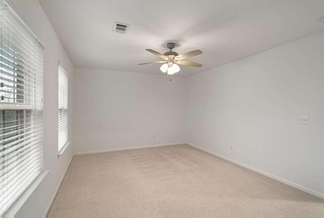 unfurnished room featuring ceiling fan and light carpet