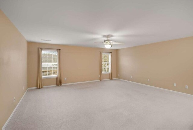 carpeted empty room with ceiling fan