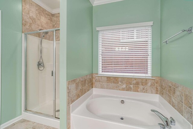 bathroom with crown molding and independent shower and bath