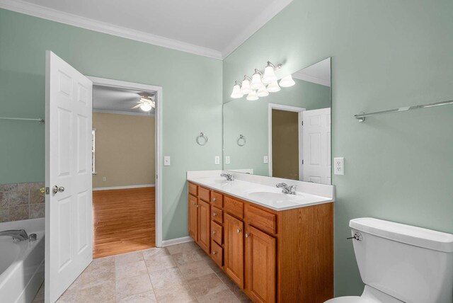 bathroom with a tub, tile patterned flooring, ornamental molding, vanity, and toilet