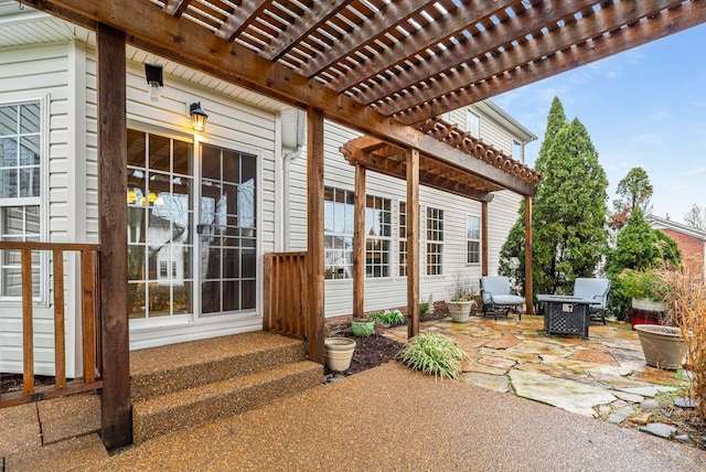 entrance to property featuring a pergola and a patio