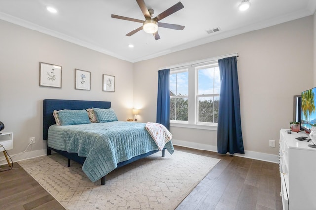 bedroom with ornamental molding, hardwood / wood-style floors, and ceiling fan