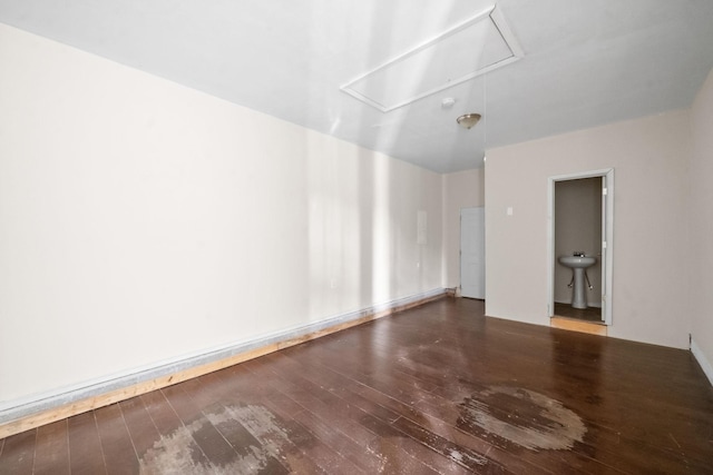 spare room featuring sink and hardwood / wood-style floors