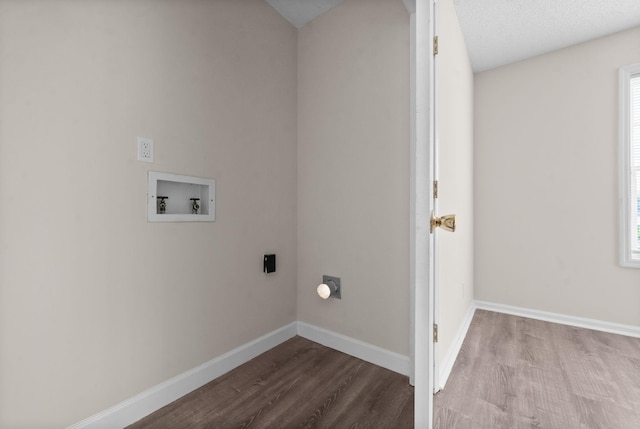 laundry room featuring electric dryer hookup, hookup for a washing machine, and light hardwood / wood-style floors