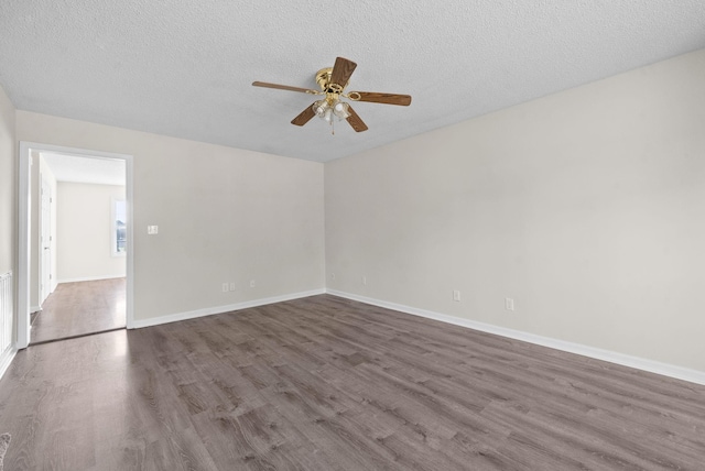 empty room with hardwood / wood-style floors, a textured ceiling, and ceiling fan