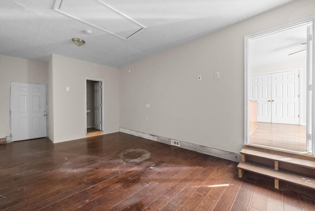 unfurnished room with dark wood-type flooring