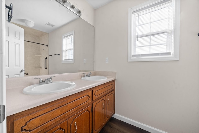 bathroom featuring vanity and a shower